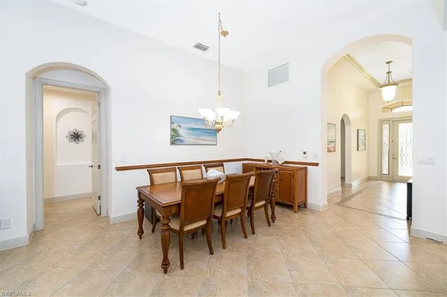 a dining room with furniture and a chandelier