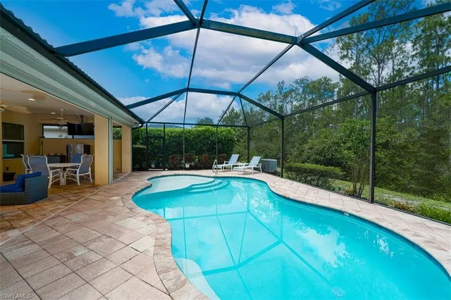 a view of a patio with a table and chairs under an umbrella