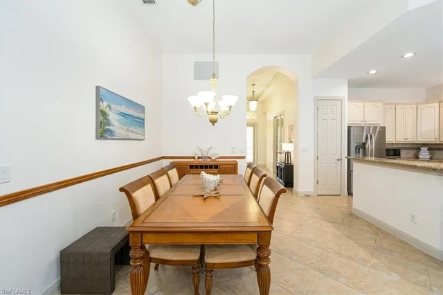 a dining room with furniture and chandelier