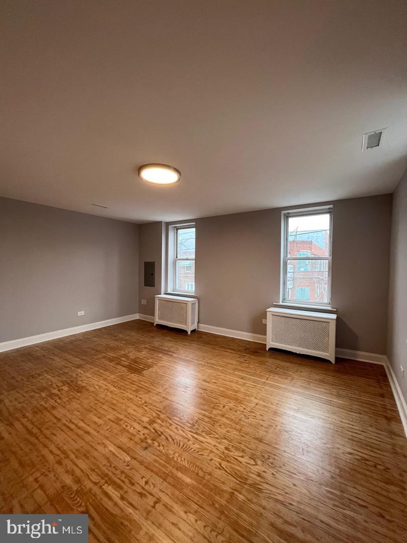 1208 Mifflin Street, Unit 2 Philadelphia, PA 19148 - Photo 6 of 14 a view of empty room with wooden floor and fan
