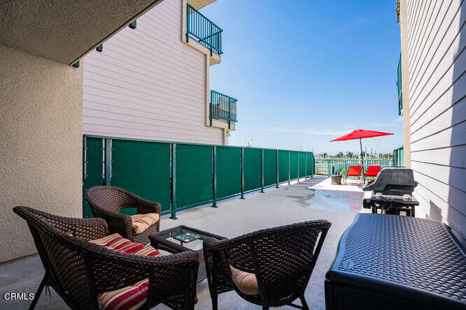 2901 Peninsula Road, Unit 132 Oxnard, CA 93035 - Photo 14 of 38 a view of a patio with a table and chairs
