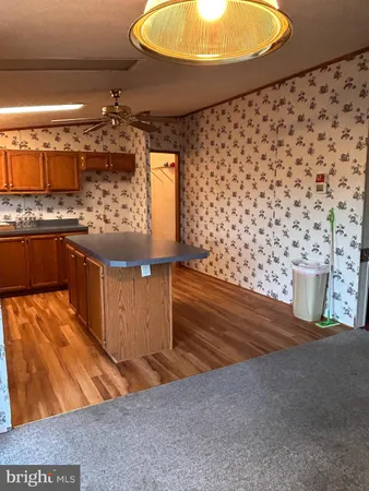 a kitchen with granite countertop a stove and cabinets