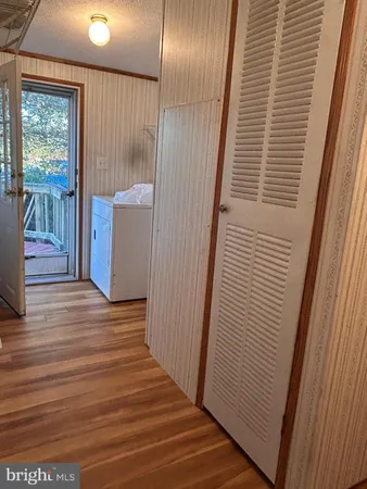 a view of a hallway view with wooden floor and staircase