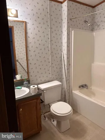 a white toilet sitting next to a bath tub and shower