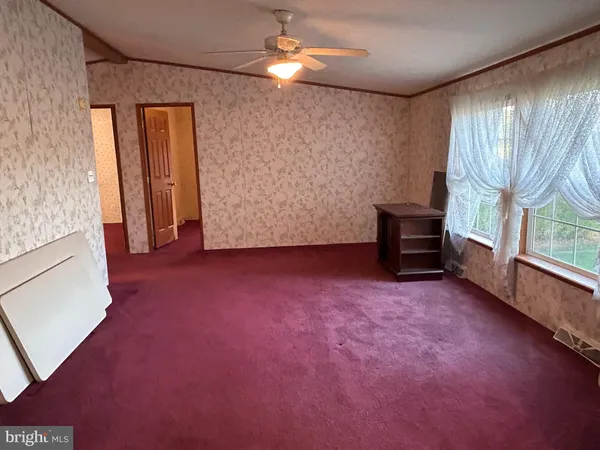 a view of empty room with floor to ceiling window