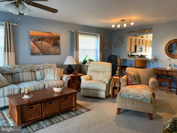 a living room with furniture a window and a fireplace