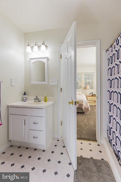 3450 Allday Road Huntingtown, MD 20639 - Photo 21 of 23 a bathroom with a sink mirror and a bath tub