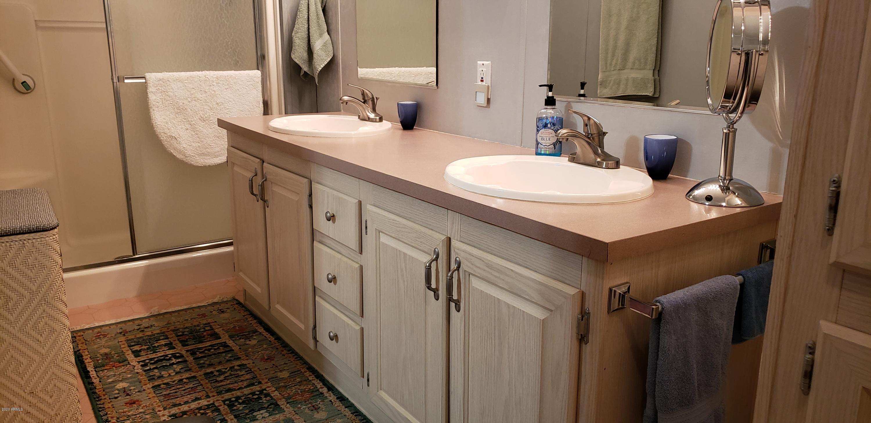 301 South Signal Butte Road, Unit 226 Apache Junction, AZ 85120 - Photo 19 of 42 a bathroom with a sink and mirror