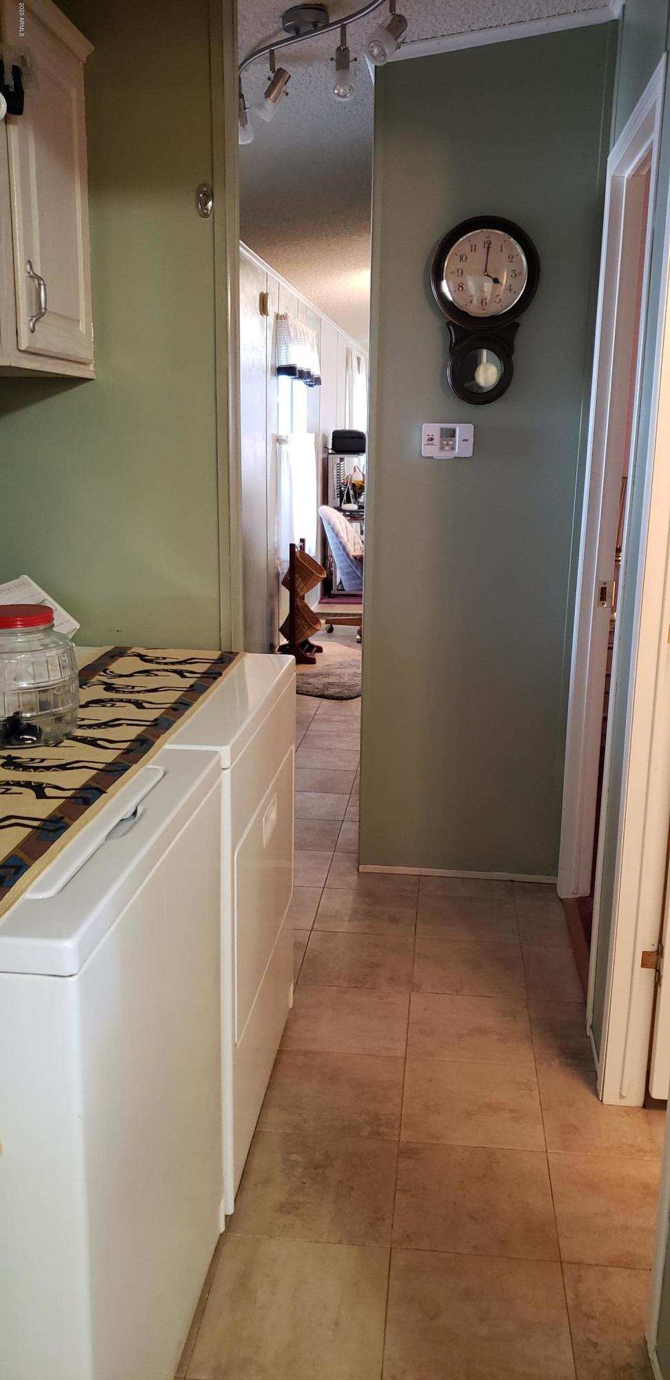 301 South Signal Butte Road, Unit 226 Apache Junction, AZ 85120 - Photo 22 of 42 a kitchen with a refrigerator and a stove