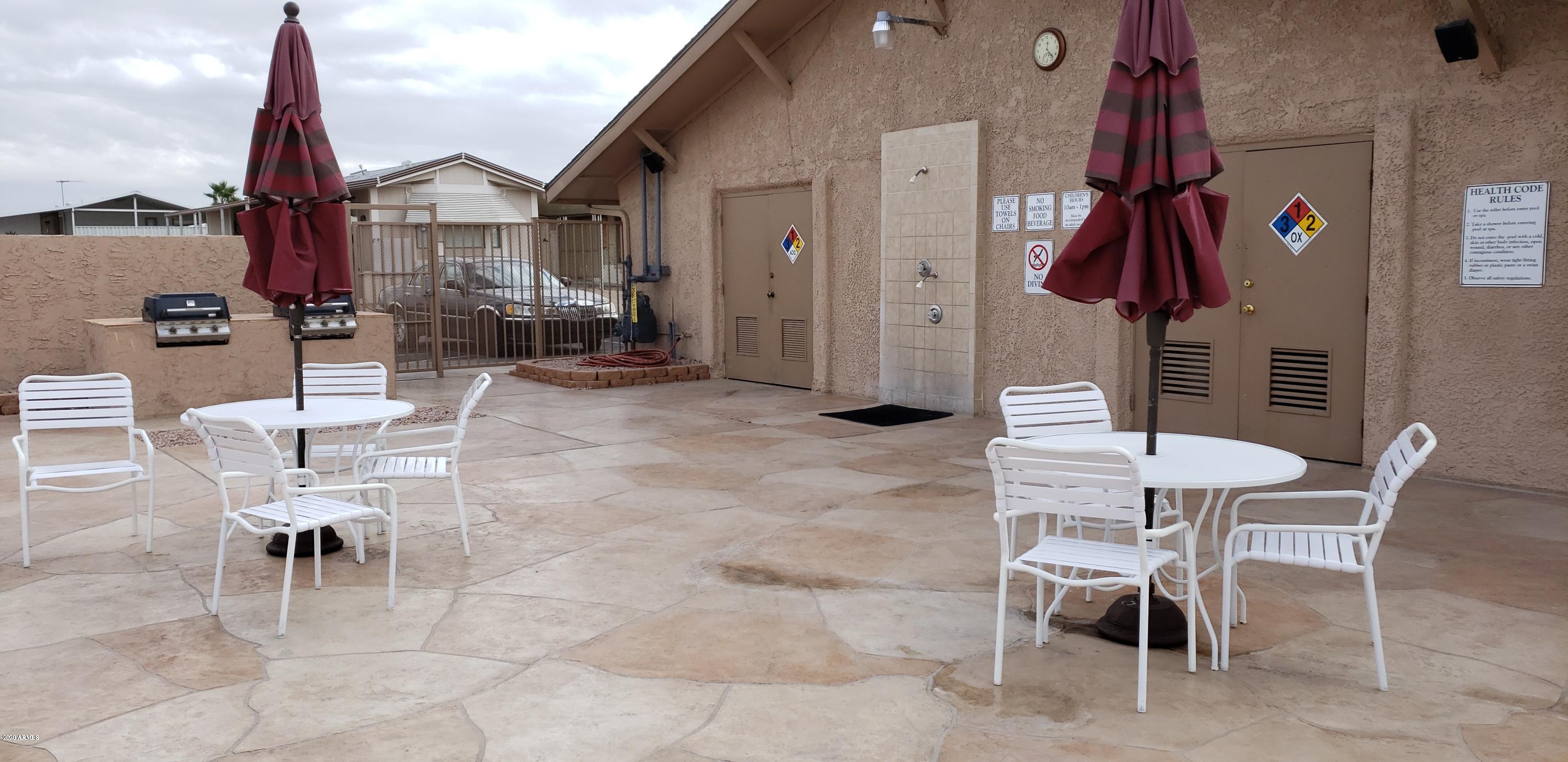 301 South Signal Butte Road, Unit 226 Apache Junction, AZ 85120 - Photo 37 of 42 a view of a patio with a table and chairs