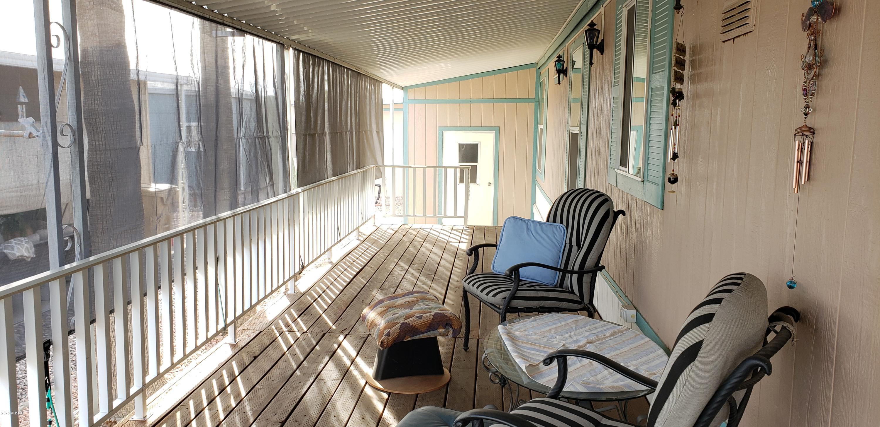 301 South Signal Butte Road, Unit 226 Apache Junction, AZ 85120 - Photo 4 of 42 a view of a balcony with chair and couch