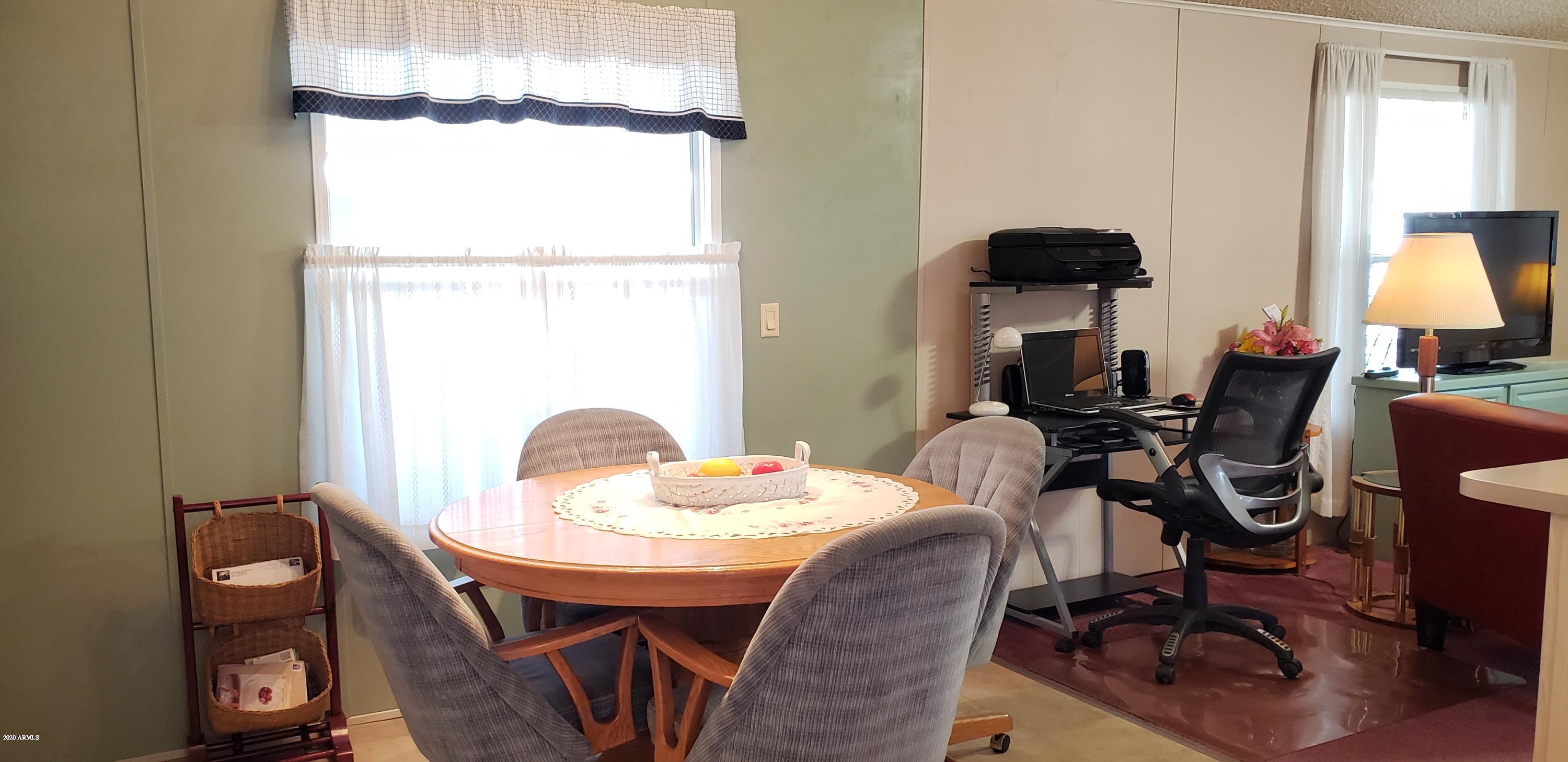 301 South Signal Butte Road, Unit 226 Apache Junction, AZ 85120 - Photo 8 of 42 a dining room with furniture and window