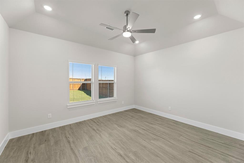 2372 Bell Way Forney, TX 75126 - Photo 12 of 39 an empty room with wooden floor fan and windows