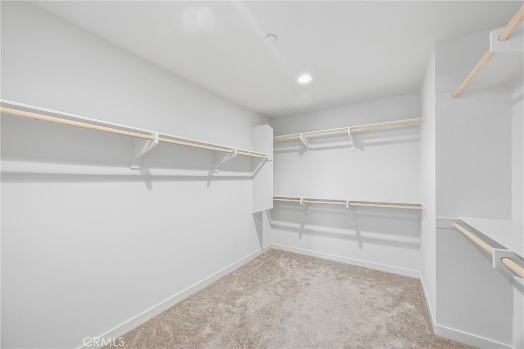 4247 Bravado Court Riverside, CA 92505 - Photo 41 of 60 Large primary walk-in closet with multiple hanging areas and shelving for organized storage