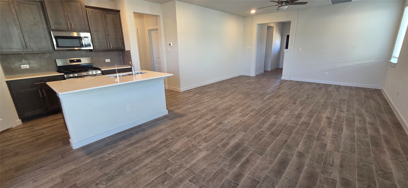 212 Whisper Rill Drive Hutto, TX 78634 - Photo 6 of 25 a room with wooden floor and black appliances