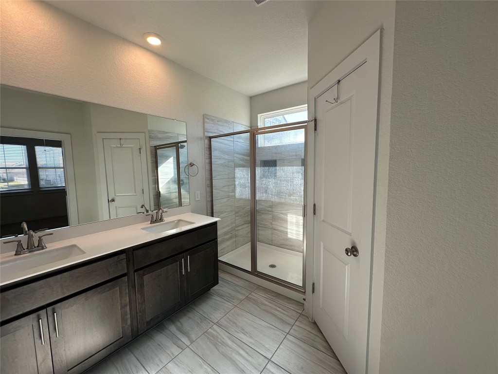 212 Whisper Rill Drive Hutto, TX 78634 - Photo 9 of 25 a bathroom with a double vanity sink mirror and double