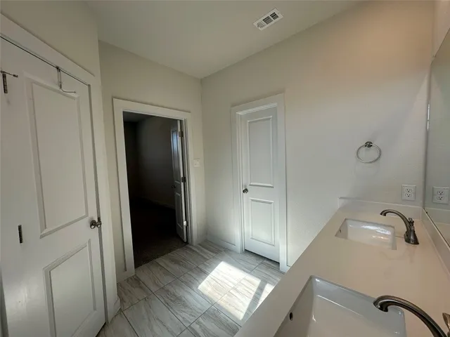 a bathroom with a sink a tub and a mirror