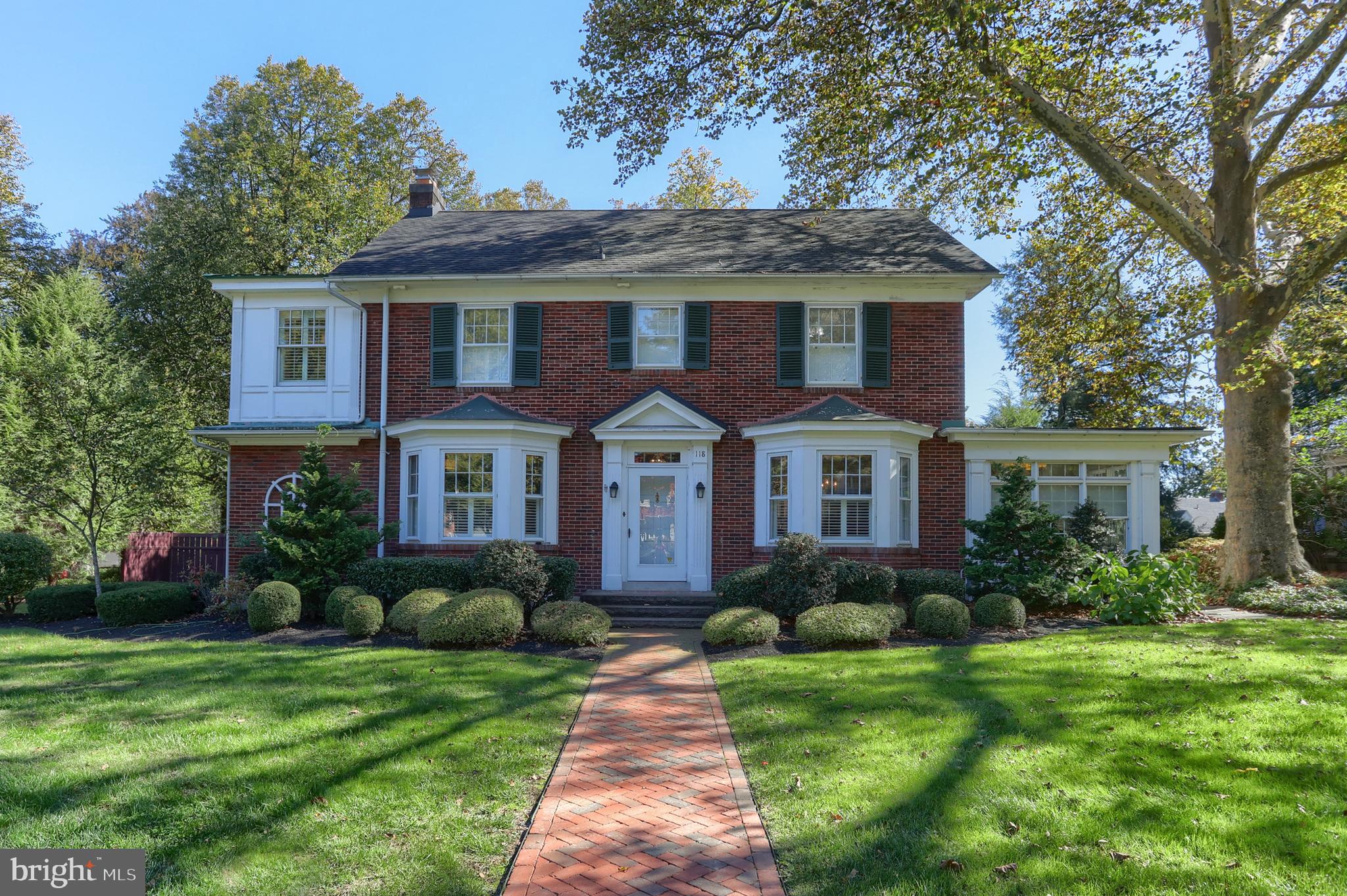 a front view of a house with a yard and potted plants