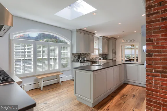 a kitchen with stainless steel appliances granite countertop a sink and a stove