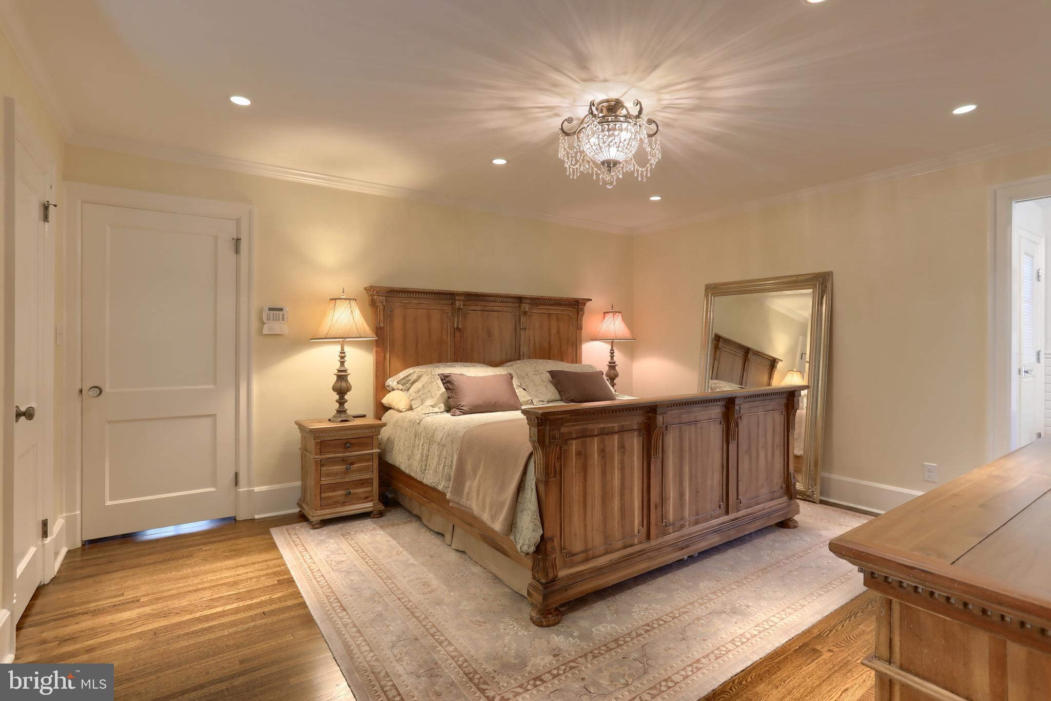 118 Elm Avenue Hershey, PA 17033 - Photo 24 of 54 a spacious bedroom with a bed and a chandelier