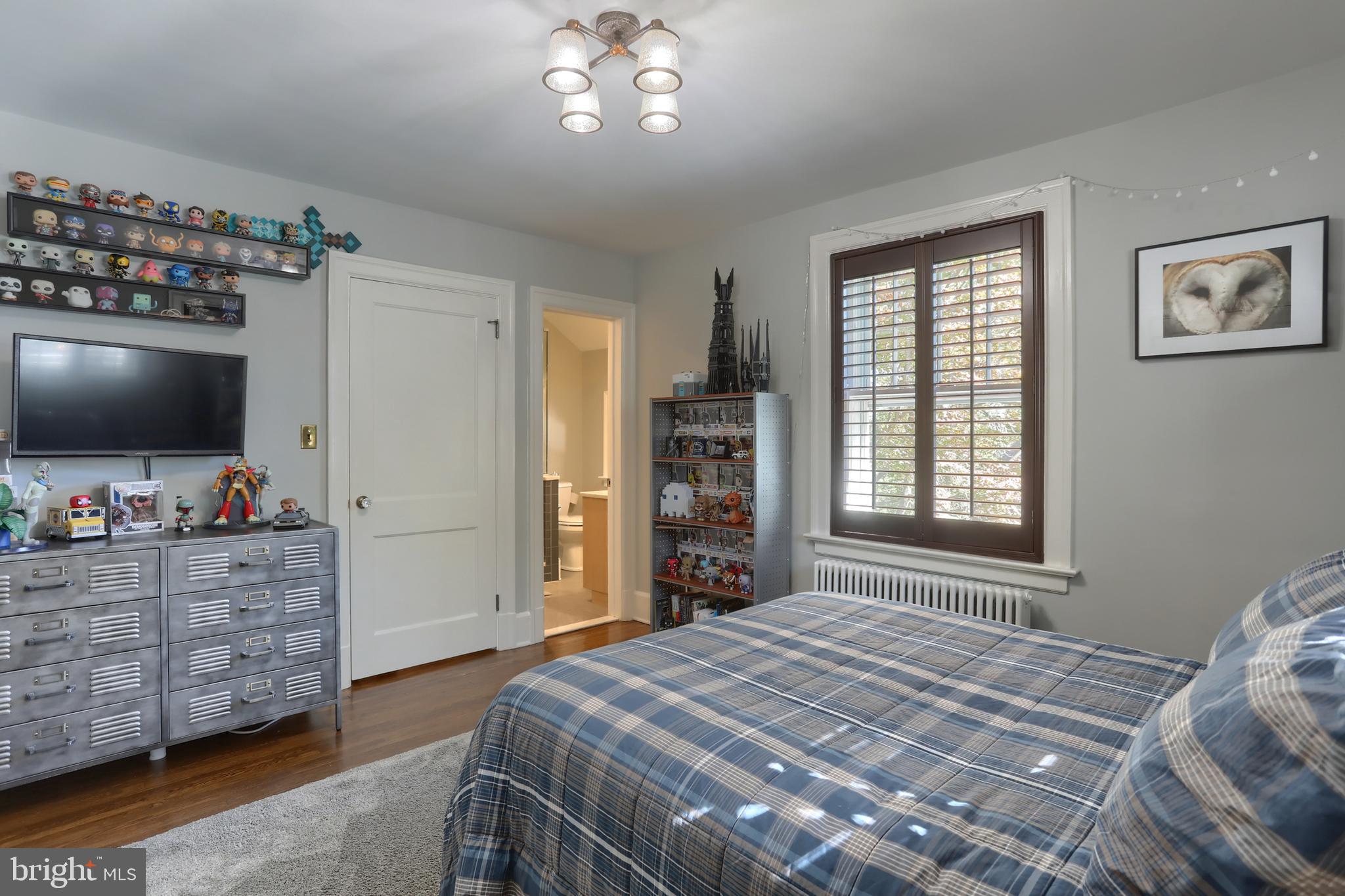 118 Elm Avenue Hershey, PA 17033 - Photo 30 of 54 a bedroom with a bed and a flat tv screen on dresser