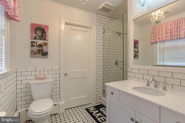 a bathroom with a toilet a sink and a shower