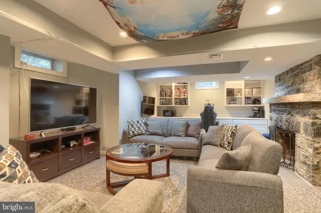 a view of a livingroom with workspace and a window