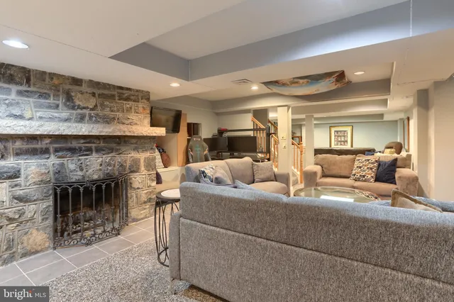 a living room with a couch and a book shelf