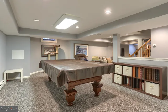 a living room with furniture and stairs