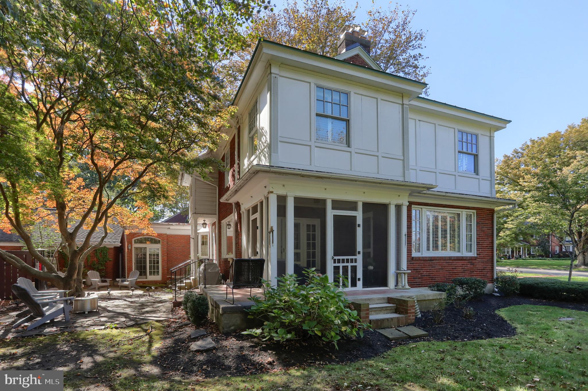 118 Elm Avenue Hershey, PA 17033 - Photo 45 of 54 a view of a brick house with many windows plants and large trees
