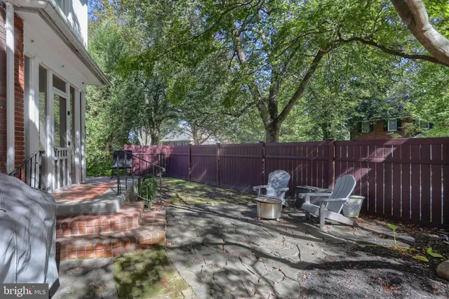 a view of a backyard with a patio and outdoor seating