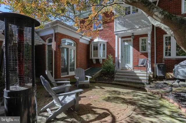 a view of a house with a tree and wooden fence