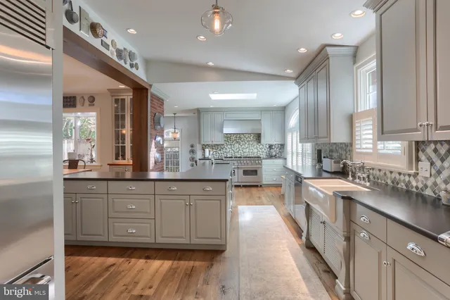 a kitchen with stainless steel appliances granite countertop a sink stove and cabinets