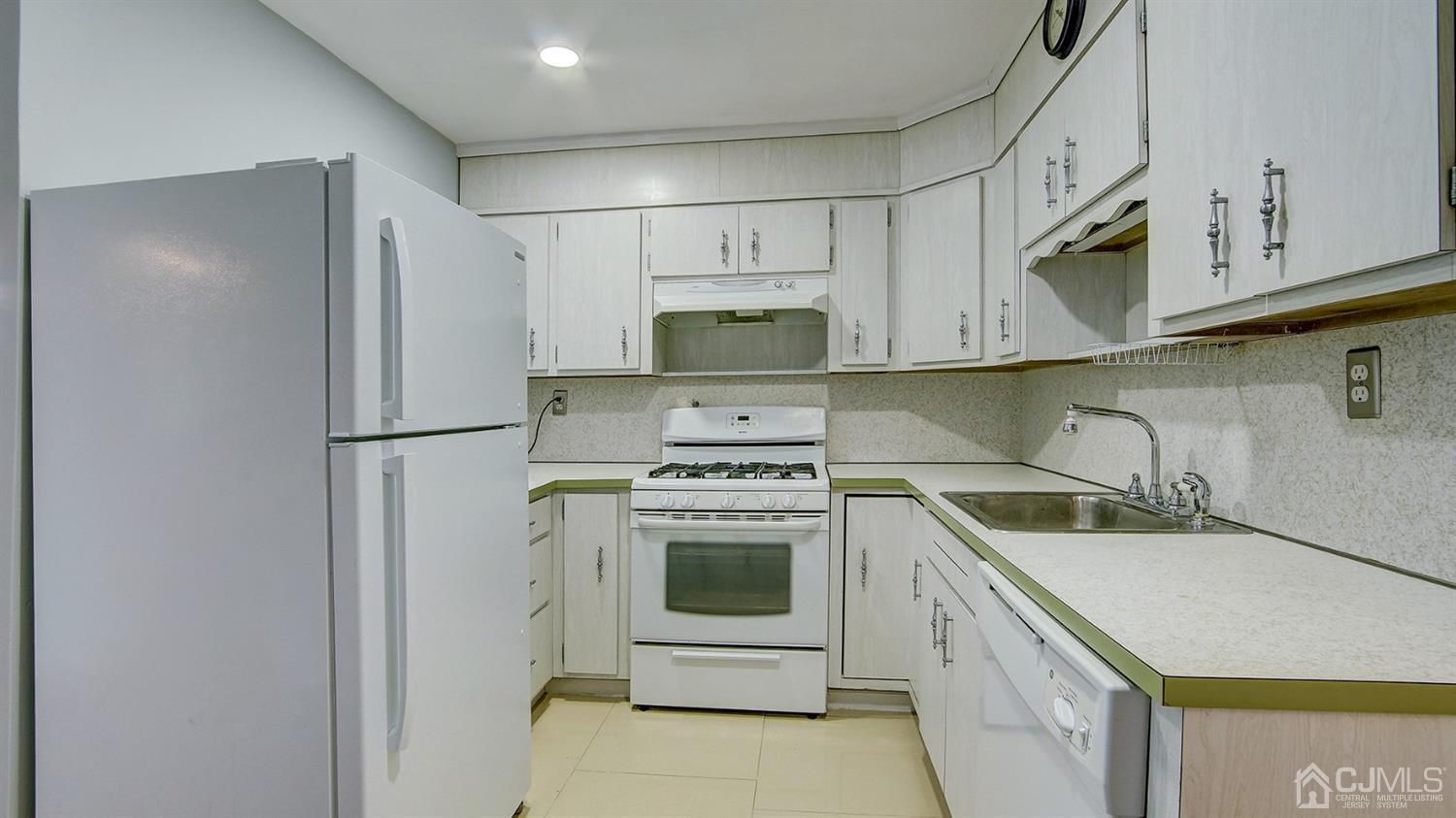 10 Melville Road Edison, NJ 08817 - Photo 11 of 32 a kitchen with stainless steel appliances granite countertop a sink stove and refrigerator