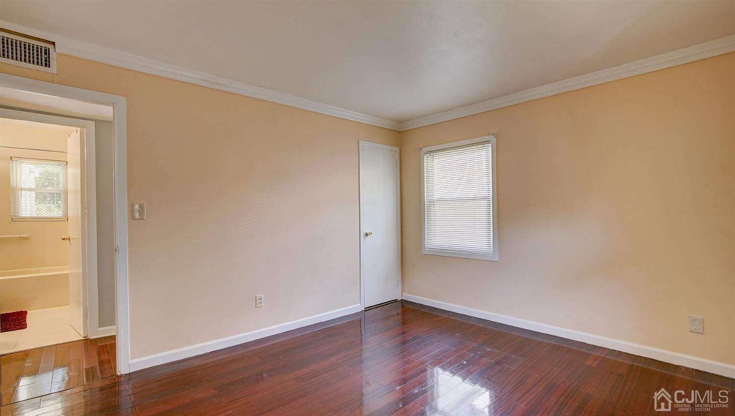 10 Melville Road Edison, NJ 08817 - Photo 15 of 32 a view of an empty room with wooden floor and a window
