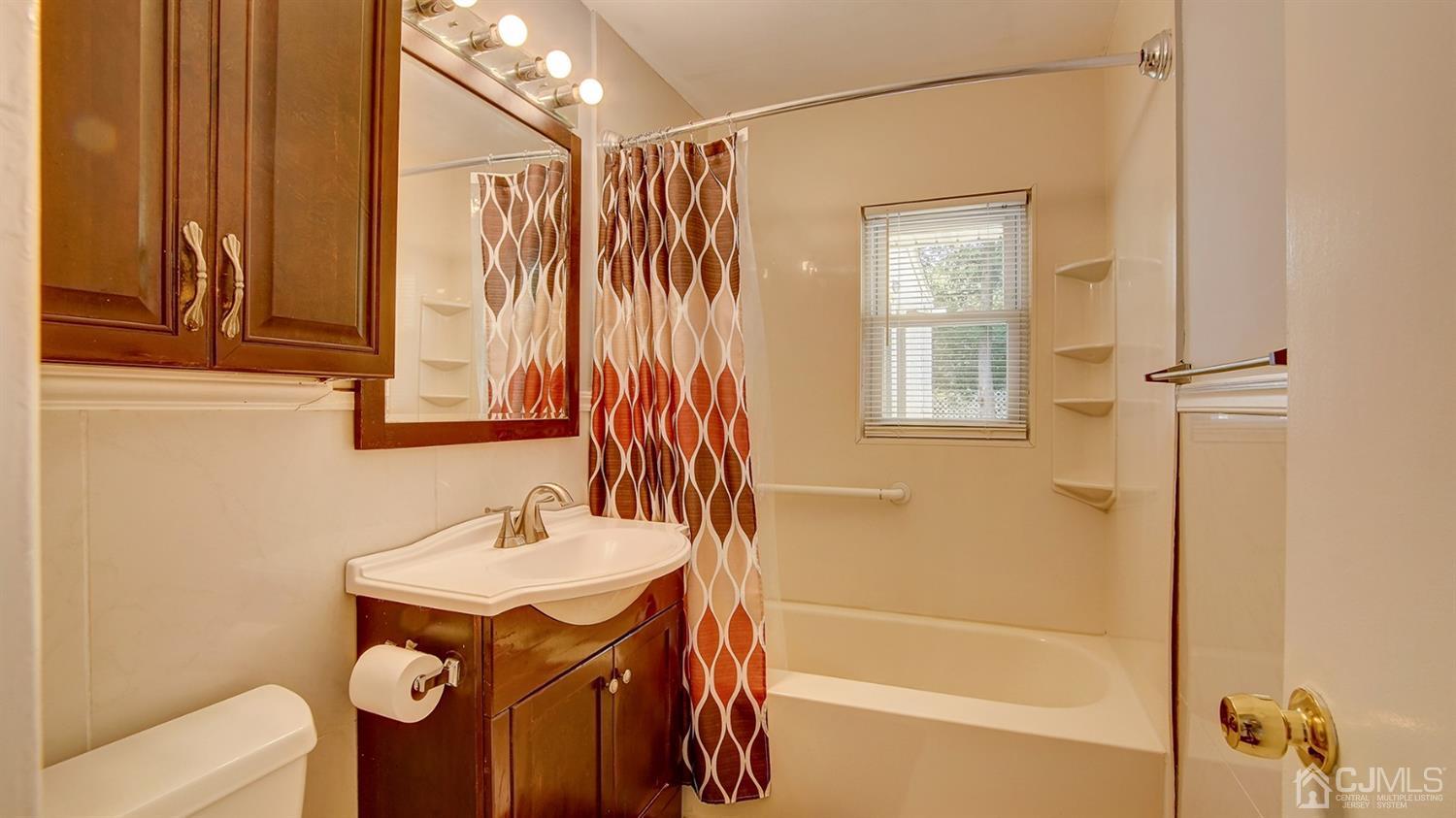 10 Melville Road Edison, NJ 08817 - Photo 17 of 32 a bathroom with a sink a toilet and shower