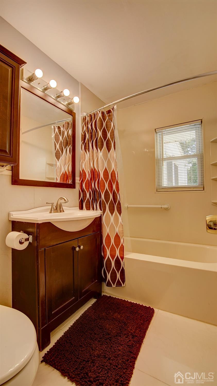 10 Melville Road Edison, NJ 08817 - Photo 18 of 32 a bathroom with a sink a toilet and shower