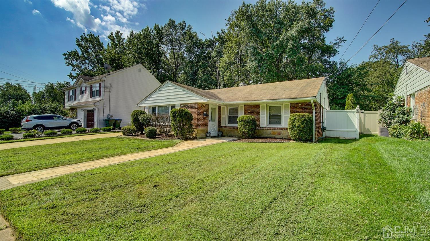 10 Melville Road Edison, NJ 08817 - Photo 3 of 32 a front view of a house with a garden and trees