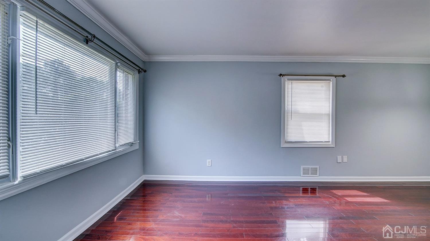 10 Melville Road Edison, NJ 08817 - Photo 5 of 32 a view of an empty room with wooden floor and a window
