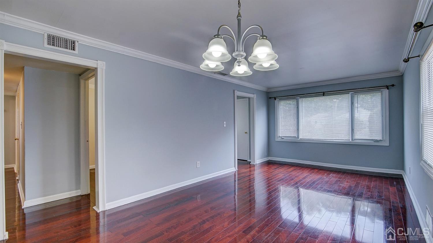 10 Melville Road Edison, NJ 08817 - Photo 8 of 32 a view of an empty room with wooden floor and a window