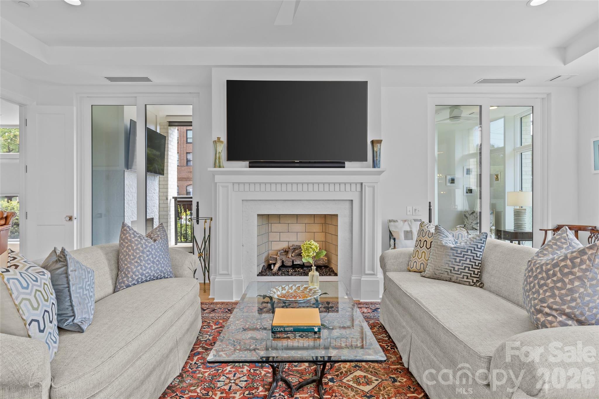 1500 Queens Road, Unit 104 Charlotte, NC 28207 - Photo 10 of 41 a living room with furniture and a flat screen tv