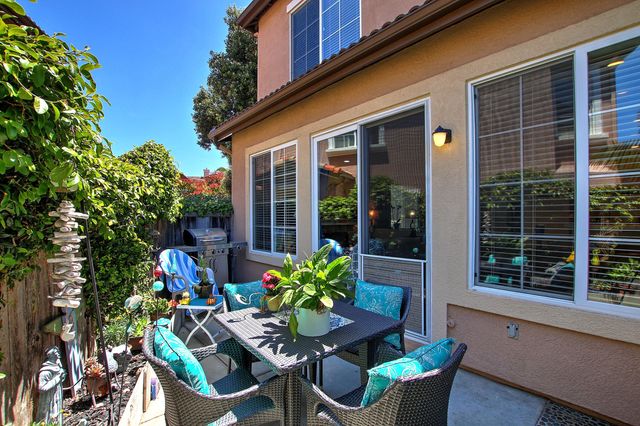 a view of a chair and table in a patio