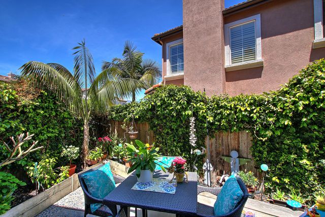 a view of a house with a porch and furniture