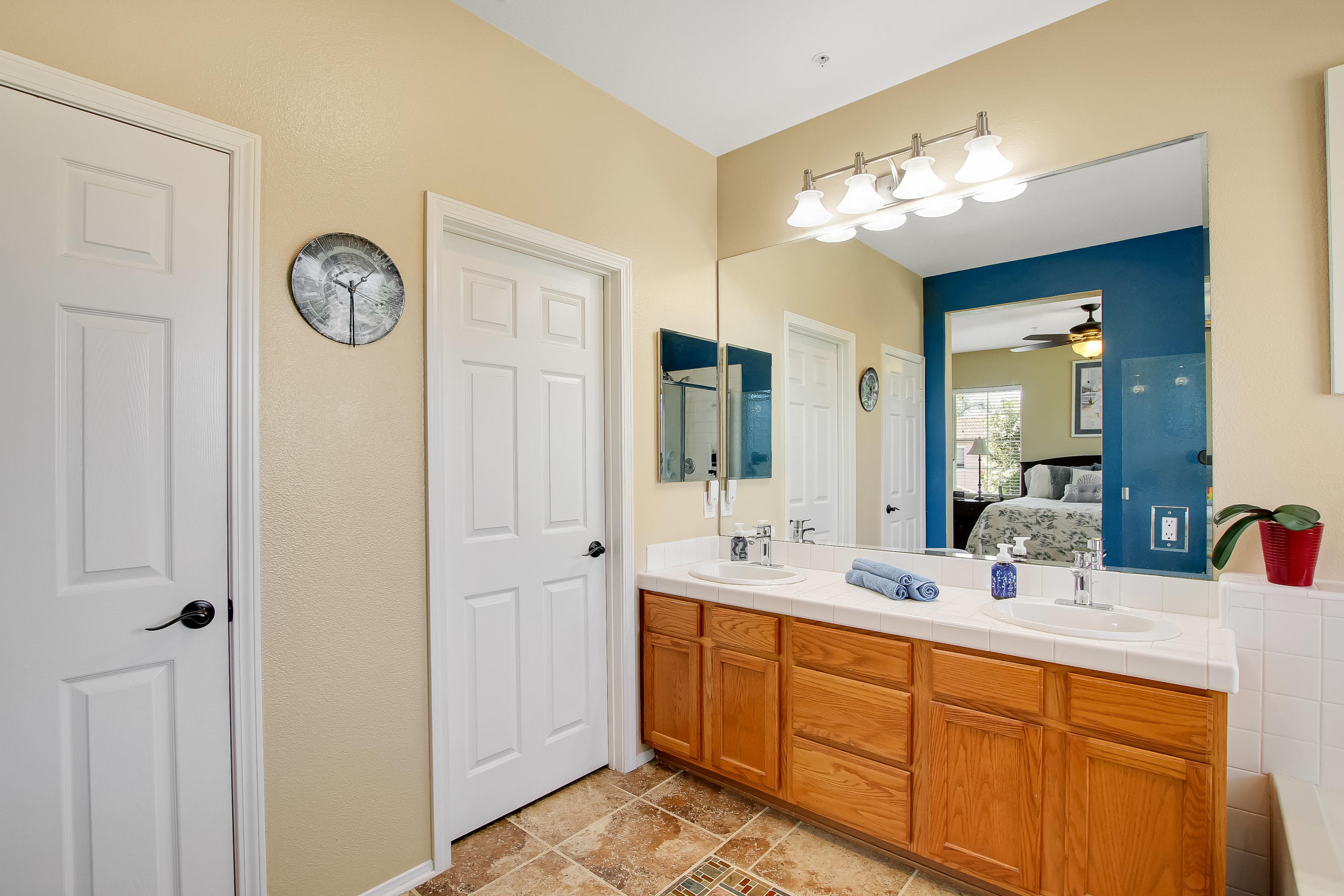 586 Poppyfield Place Goleta, CA 93117 - Photo 19 of 37 a bathroom with a double vanity sink and a mirror