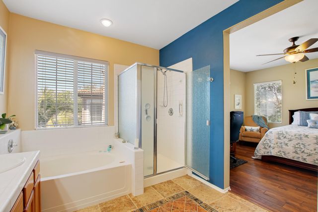 a view of a bedroom with tub and windows