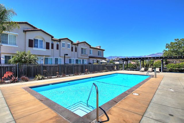 a view of a swimming pool with a lounge chairs