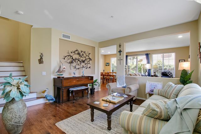 a living room with furniture coffee table and a potted plant