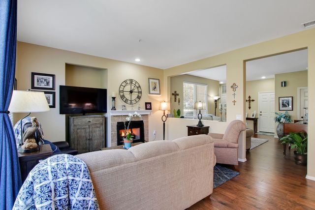 a living room with fireplace furniture and a flat screen tv