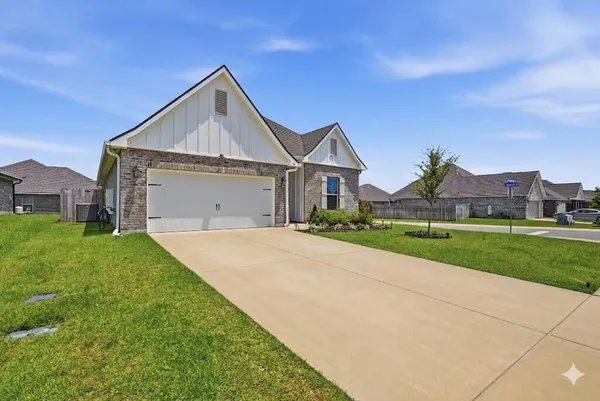 a front view of house with yard and green space