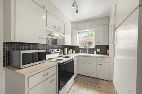 a kitchen with a sink stove and cabinets
